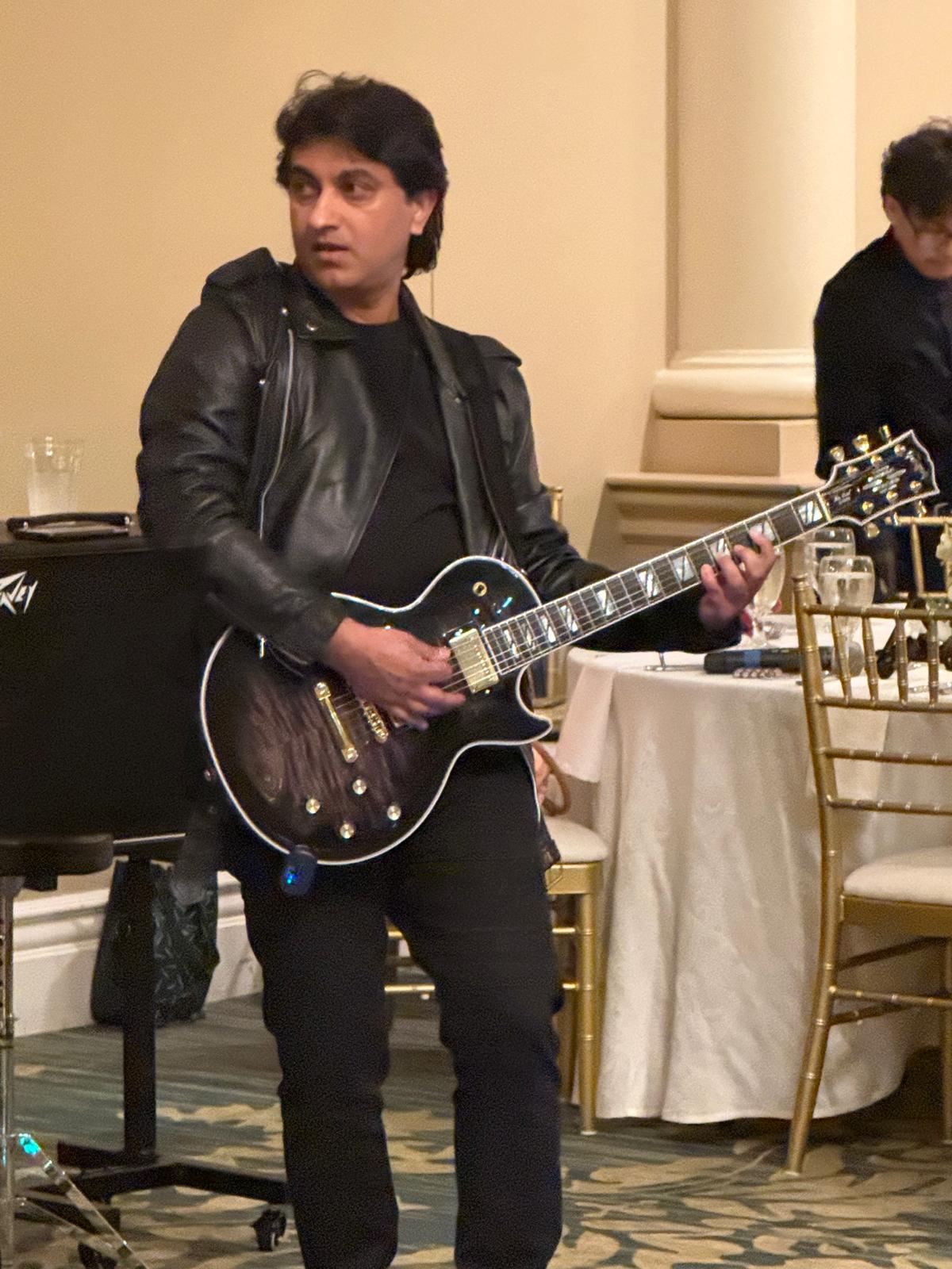 Guitarist in leather jacket performing